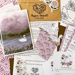 May include: A collection of stationery items including a brown envelope with the text Paper Heart MAIL CLUB, a swan and flower illustration print, swan stickers, and a monthly reflection card with the text The Month Ahead and Gentle To-Do List.