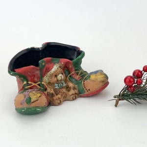 Vintage Christmas themed decorative ceramic boots with a teddy bear