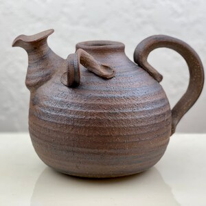 Dark brown unique ceramic jug or vase with handle