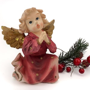 Christmas souvenir European-made ceramic vintage figurine of a singing angel.