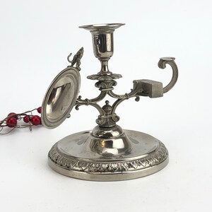 Vintage candlestick holder with a clock holder and a handle