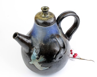 Unusual  hand painted vintage teapot with two handles made of dark ceramics