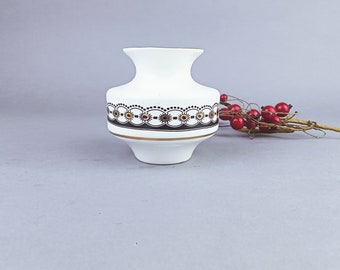 Small vase made of white porcelain with geometric decoration. Made in Lithuania.