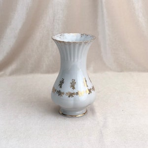Porcelain white and gold vintage vase for flowers.