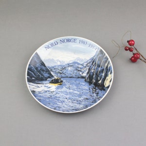 Vintage decorative plate from Norway depicting a fishing boat and seagulls on a Troll-fjord background