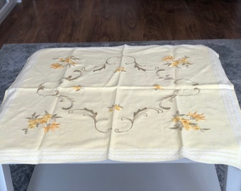 Sown decorative tablecloth with flower decorations