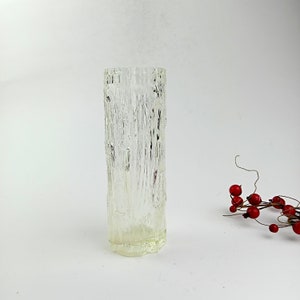 Vintage vase for flowers with a corrugated surface, made of thin yellow glass.