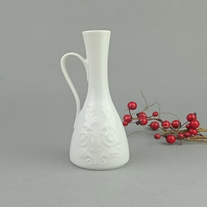 Decorative vase made of white fine porcelain with a pattern