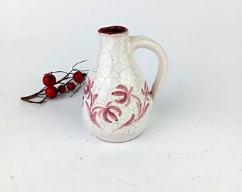 Miniature decorative white jug with krikle and brown painting.