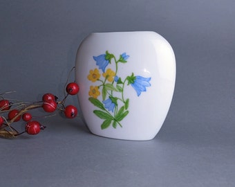 Vintage white porcelain vase depicting wild flowers