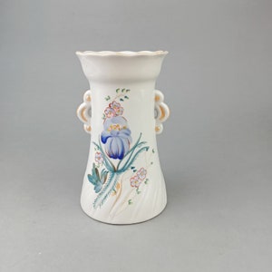 Vintage vase made of white porcelain with hand painting in Polonnoe
