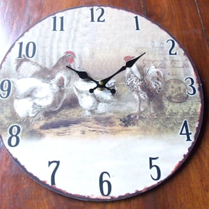 May include: Round wall clock with a rustic design featuring illustrations of chickens and a rooster. The clock face has black numerals and hands, with a distressed, vintage-style border. The clock measures approximately 12 inches in diameter.
