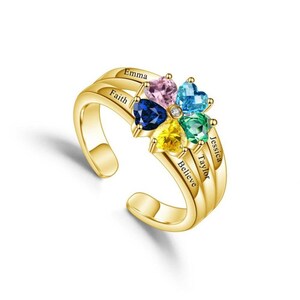 May include: A gold ring featuring a flower design with heart-shaped gemstones in pink, blue, yellow, and green. The ring is engraved with the names "Emma", "Faith", "Believe", "Jessica", and "Taylor". The ring is a statement piece.