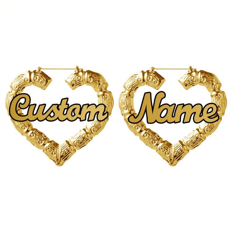 May include: A pair of gold heart-shaped hoop earrings with the words "Custom" and "Name" written in black cursive lettering.
