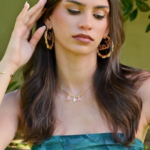 Trendy colorful enamel name necklace styled as statement choker jewelry