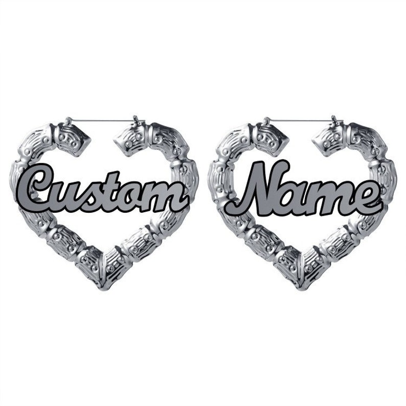 May include: A pair of silver heart-shaped hoop earrings with the words "Custom" and "Name" inscribed on them.
