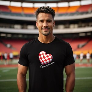 May include: A black t-shirt featuring a red and white chequered heart design with the text "Samo je jedno" in white script.