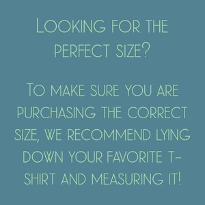 May include: Text on a blue background that reads: "Looking for the perfect size? To make sure you are purchasing the correct size, we recommend lying down your favourite t-shirt and measuring it!"