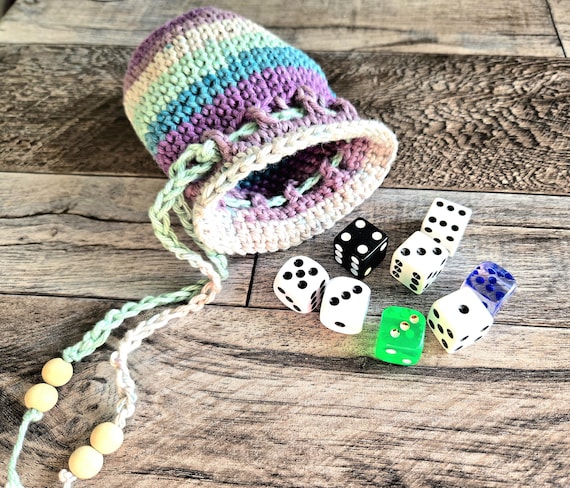 A hand-crocheted drawstring dice bag that doubles as a crystal or earbud pouch — charming nerdy craft at a great price point.