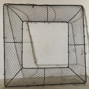 May include: A square-shaped metal wire frame with a diamond pattern. The frame is made of thin wire and has a rustic, vintage look.