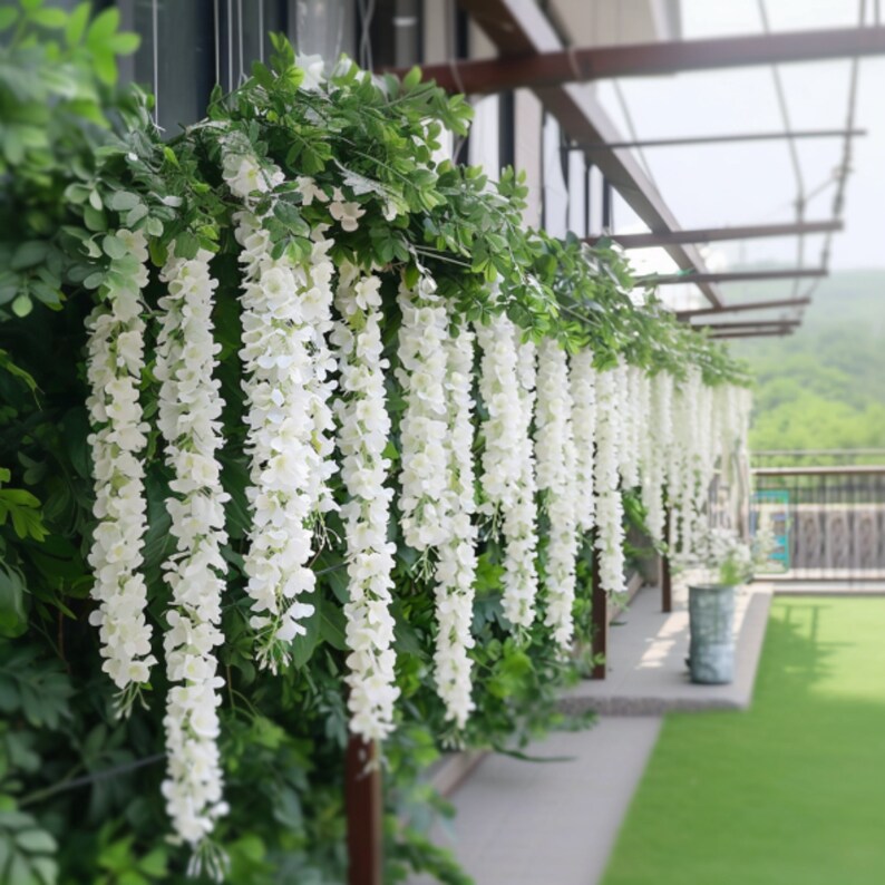 Close-up of white wisteria garland hanging elegantly for wedding decoration.