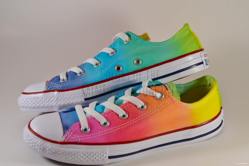 white converse with rainbow stitching