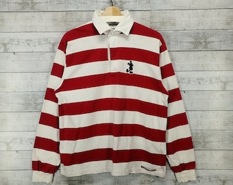 May include: Red and white striped long-sleeve rugby shirt with a black Mickey Mouse silhouette on the left chest.