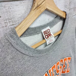 May include: Gray sweatshirt with a red "Red Oak" tag and the word "Tennessee" in orange letters on the front.