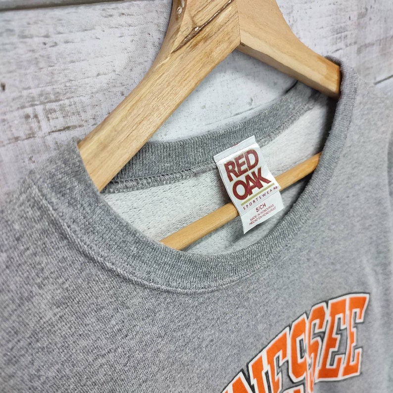 May include: Gray sweatshirt with a red "Red Oak" tag and the word "Tennessee" in orange letters on the front.