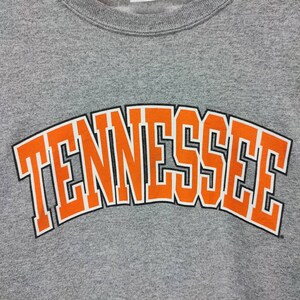 May include: Gray sweatshirt with an orange "Tennessee" graphic.