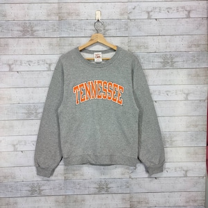 May include: Gray sweatshirt with a large orange "TENNESSEE" graphic on the front. The sweatshirt has a crew neck and long sleeves.