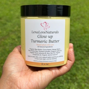 May include: A 16 ounce jar of turmeric butter labeled "LenaLoveNaturals Glow up Turmeric Butter" with a list of all natural ingredients including shea butter, cocoa butter, mango butter, raw honey, raw turmeric powder, jojoba oil, sweet almond oil, rose hip oil, grapeseed oil, and apricot seed oil.