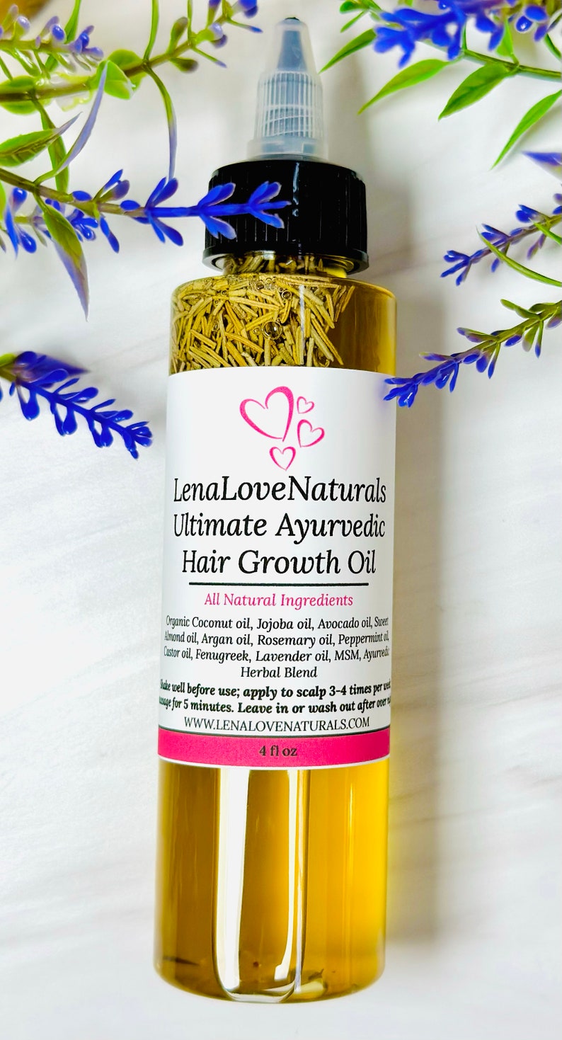 May include: A 4-ounce bottle of LenaLoveNaturals Ultimate Ayurvedic Hair Growth Oil. The bottle is clear glass and contains a yellow liquid. The label is white with pink accents and lists all-natural ingredients, including coconut oil, jojoba oil, avocado oil, sweet almond oil, argan oil, rosemary oil, peppermint oil, castor oil, fenugreek, lavender oil, MSM, and ayurvedic herbal blend.