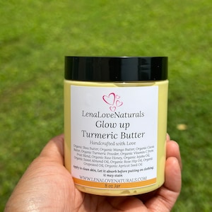 May include: A yellow jar of turmeric butter labeled "LenaLove Naturals Glow up Turmeric Butter Handcrafted with Love". The jar is 8 oz and lists the ingredients: Organic Shea Butter, Organic Mango Butter, Organic Cocoa Butter, Organic Turmeric Powder, Organic Vitamin C Fruit Blend, Organic Raw Honey, Organic Jojoba Oil, Organic Sweet Almond Oil, Organic Rose Hip Oil, Organic Grapeseed Oil, Organic Apricot Seed Oil. The label also says "Apply to clean skin, Let it absorb before putting on clothing; it may stain." and "WWW.LENALOVENATURALS.COM".