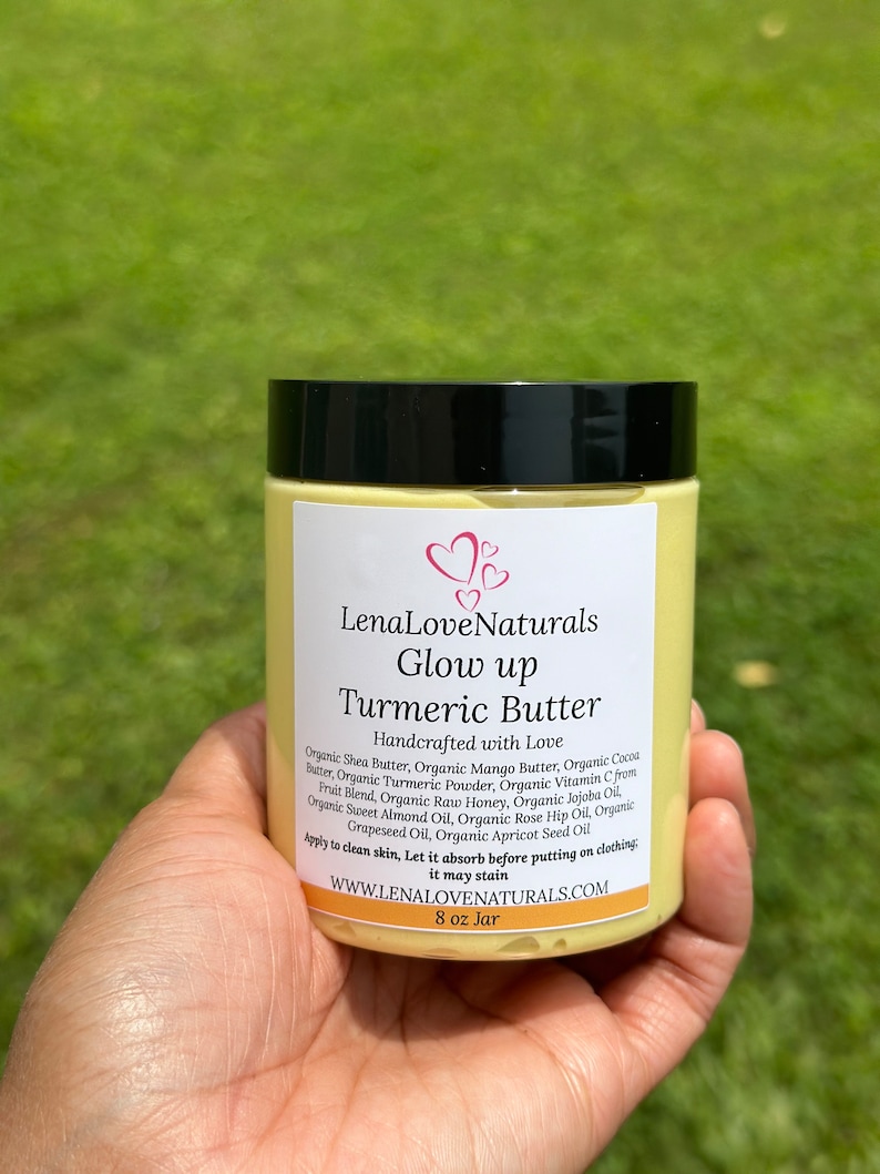 May include: A yellow jar of turmeric butter labeled "LenaLove Naturals Glow up Turmeric Butter Handcrafted with Love". The jar is 8 oz and lists the ingredients: Organic Shea Butter, Organic Mango Butter, Organic Cocoa Butter, Organic Turmeric Powder, Organic Vitamin C Fruit Blend, Organic Raw Honey, Organic Jojoba Oil, Organic Sweet Almond Oil, Organic Rose Hip Oil, Organic Grapeseed Oil, Organic Apricot Seed Oil. The label also says "Apply to clean skin, Let it absorb before putting on clothing; it may stain." and "WWW.LENALOVENATURALS.COM".