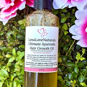 May include: A clear glass bottle with a black cap and a white label that reads "Lena Love Naturals Ultimate Ayurvedic Hair Growth Oil". The bottle is filled with a light green liquid and is surrounded by pink and green flowers.