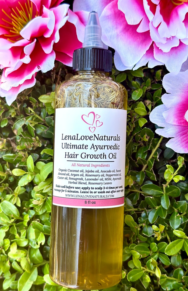 May include: A clear glass bottle with a black cap and a white label that reads "Lena Love Naturals Ultimate Ayurvedic Hair Growth Oil". The bottle is filled with a light green liquid and is surrounded by pink and green flowers.