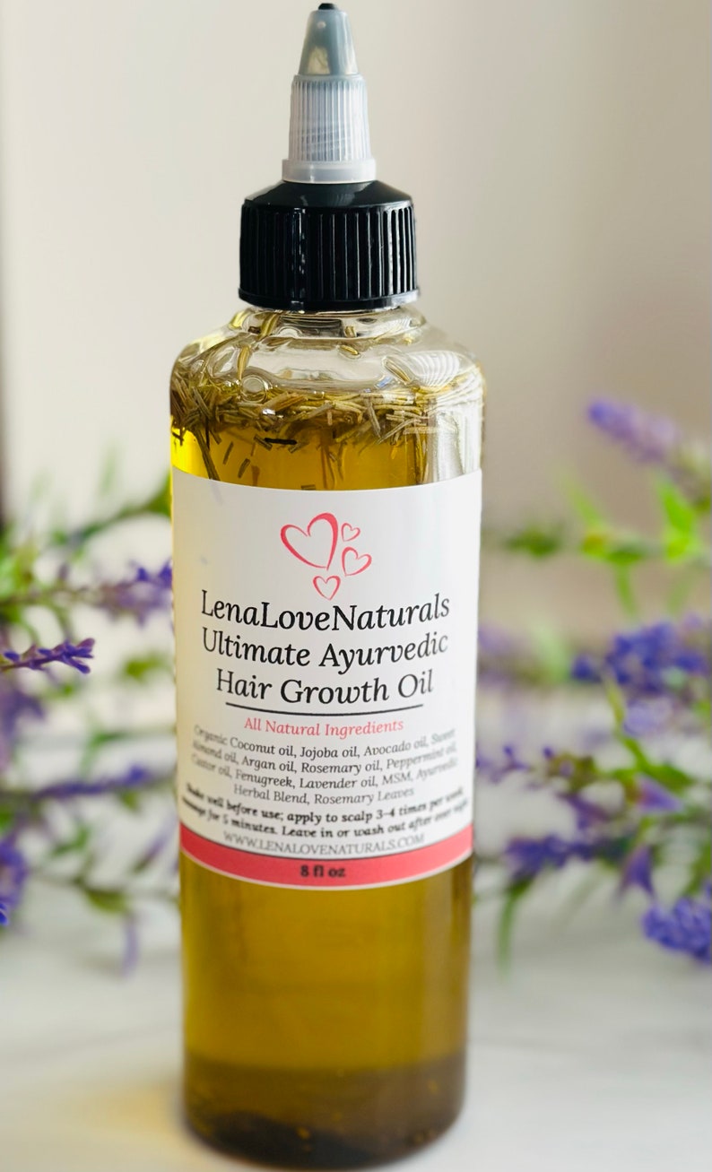 May include: A clear glass bottle with a black cap and a white label. The label reads "Lena Love Naturals Ultimate Ayurvedic Hair Growth Oil" and lists all natural ingredients. The bottle is filled with a yellow liquid and contains herbs. The bottle is 8 fl oz.