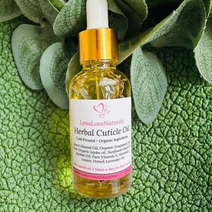 May include: A clear glass bottle of Lena Love Naturals Herbal Cuticle Oil with a gold cap and white dropper. The label lists ingredients like Sweet Almond Oil and French Lavender Oil. The bottle is 1 fl oz.