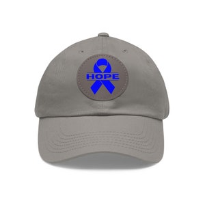 May include: A gray baseball cap with a blue ribbon and the word "HOPE" on a brown patch.