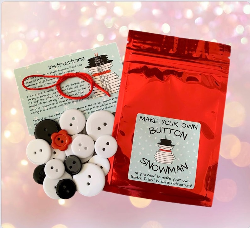 May include: A craft kit to make your own button snowman. The kit includes a variety of black and white buttons, red buttons, and a length of string. The instructions are printed on a card with a picture of a snowman made of buttons.
