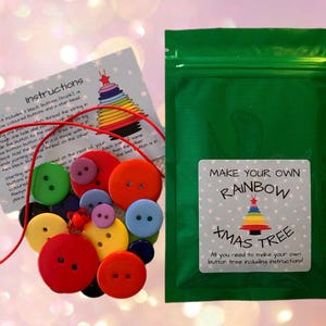 May include: A green zippered bag with a white label that says "Make Your Own Rainbow Xmas Tree. All you need to make your own button tree including instructions." The bag contains a red string and a variety of colorful buttons.