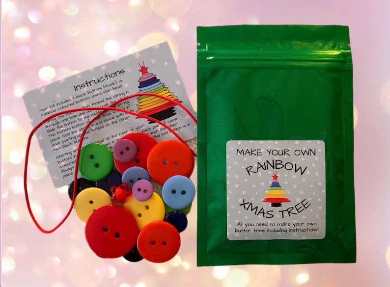 May include: A green zippered bag with a white label that says "Make Your Own Rainbow Xmas Tree. All you need to make your own button tree including instructions." The bag contains a red string and a variety of colorful buttons.