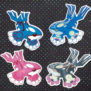 May include: Four colourful stickers featuring cartoon-like depictions of water-type Pokemon. The stickers are printed on a white background and feature blue, pink, and black colours.