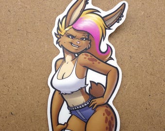 May include: A sticker of a cartoon bunny girl with brown fur, a white top, denim shorts, and striped thigh-high socks. Her hair has pink and yellow highlights. The sticker is surrounded by other colourful stickers on a brown surface.
