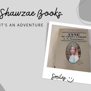 May include: A vintage paperback copy of "Anne of Green Gables" by L.M. Montgomery. The cover features a photo of a young woman with long brown hair, set against a green background. The book is in a white Polaroid frame with the text "Shawzae Books" and "It's an adventure" above the frame and "Smiles" below the frame.