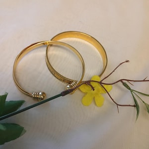 Avon Vintage Goldtone Multi Ingual Etched Bangle with a Goldtone Cuff Bracelet Size 7