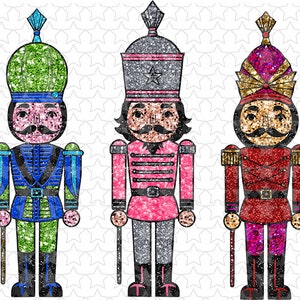 May include: Three glitter nutcracker figurines, one green, one pink, and one red. Each nutcracker has a mustache and a black hat with a star on top.