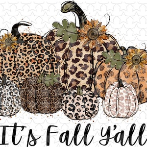 May include: A group of six pumpkins with a leopard print design. The pumpkins are arranged in a row with the largest pumpkin in the center. The pumpkins are decorated with glitter and sunflowers. The text "It's Fall y'all" is written below the pumpkins.