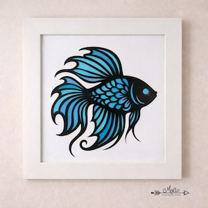 May include: A framed art print featuring a stylized black and blue betta fish illustration. The fish has flowing fins and a detailed design, set against a white background within a white frame. The artwork is signed by the artist.